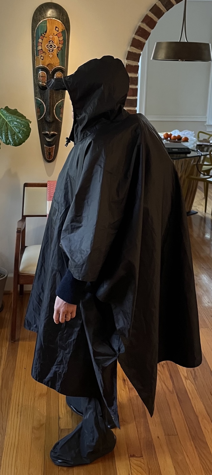 Rachel in a black poncho at home — a reenactment of the rain-soaked Lisbon ceramics trip